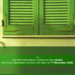 square, eye-level shot of a building exterior with a closed, bright green wooden shutter. The shutter is made of two panels with horizontal slats and is framed by a lighter green trim. Below the window is a wall painted in two shades of green, with a darker stripe at the bottom. Below the image, centered in white text, are three dots, followed by the text: "Our first submission window is now closed. Our next submission window will open on 1st November 2025."